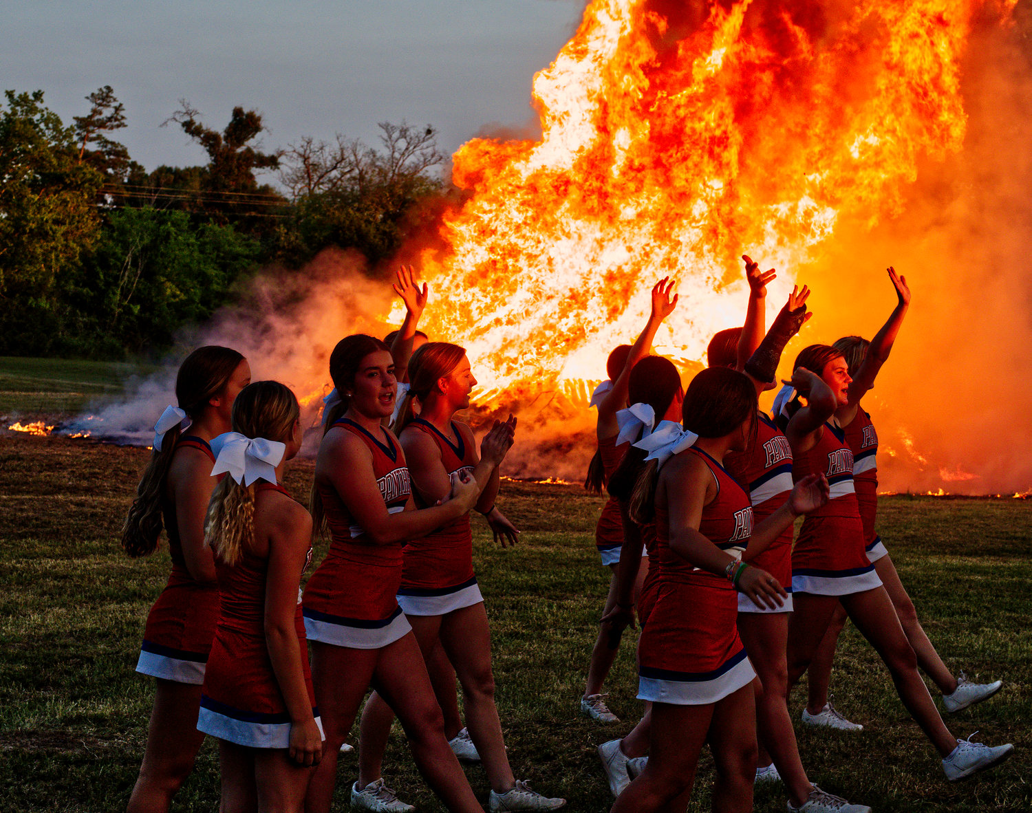 Alba-Golden High School cheerleaders pep up the crowd at the homecoming bonfire held last Wednesday night near the school. [find more photos of festivities and fire]